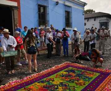 A group watching Easter carpets being made