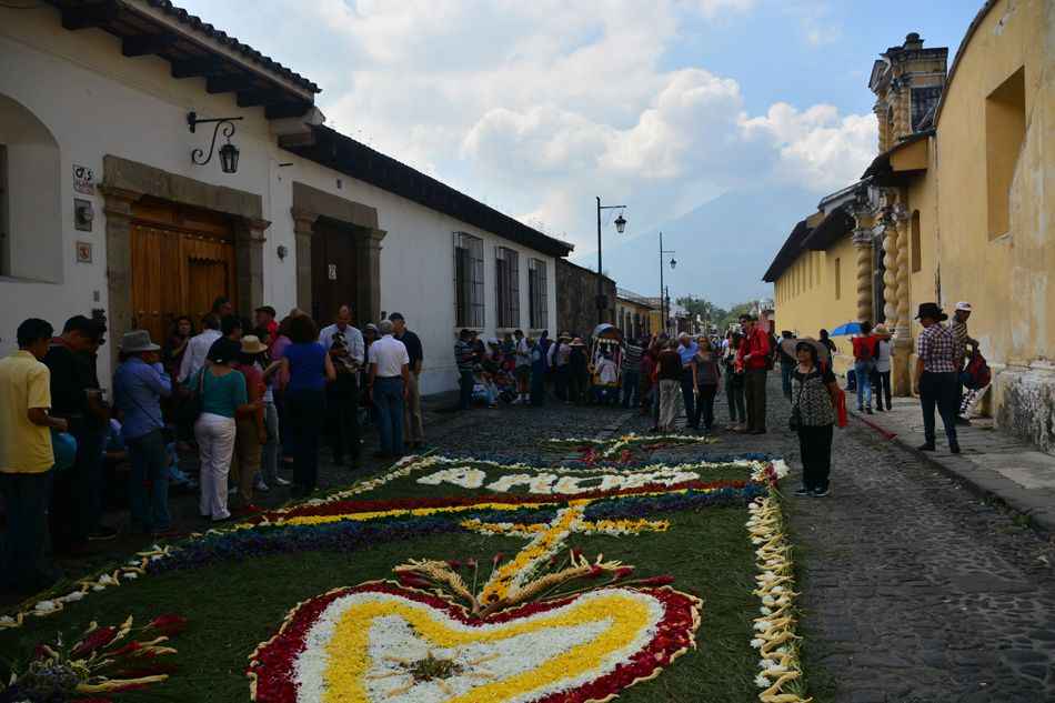 A group watches the 'alfombras' being created