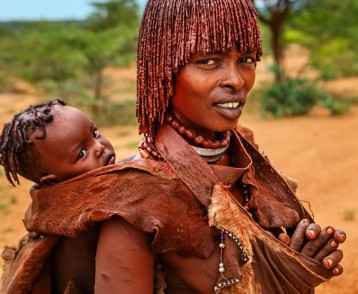 Woman from Hamer tribe carrying her baby, Ethiopia, Africa