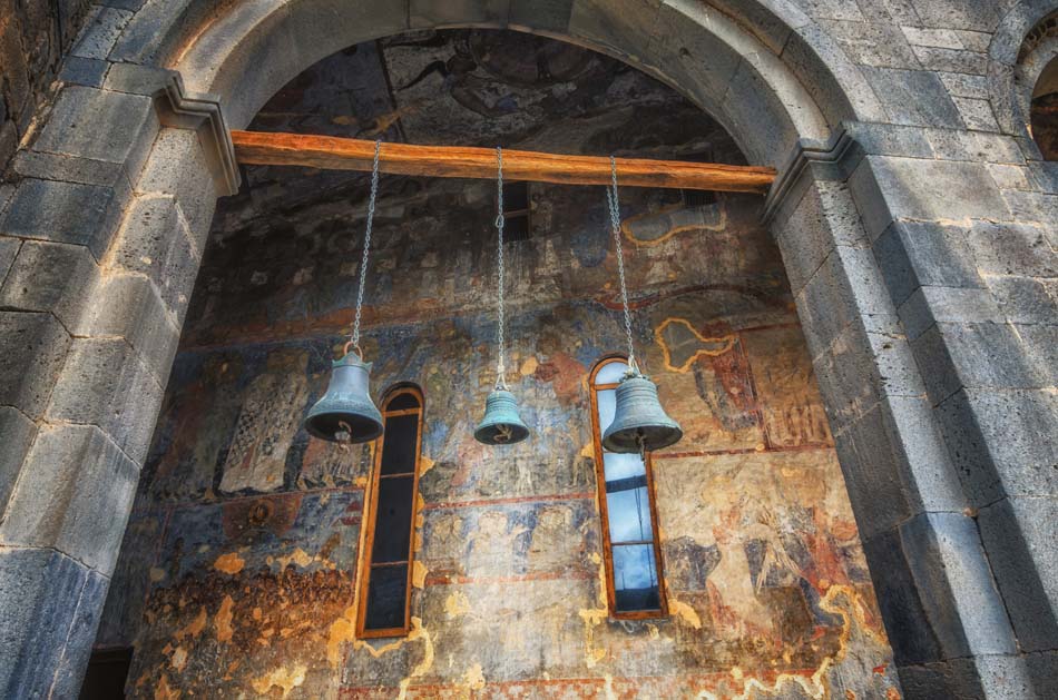 Church of Dormition in Vardzia cave ancient monastery in Samtskhe-Javakheti region, Georgia. Old bells hang from ceiling